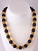 BN42 carved blk plastic/applejuice bakelite necklace